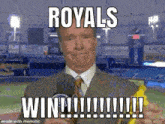 a man in a suit and tie is holding a banana in front of a microphone and saying `` royals win ! ''
