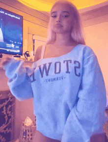 a woman is wearing a blue sweater that says wote
