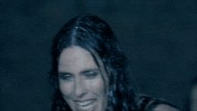 a close up of a woman 's face with long dark hair