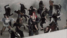a woman with red hair is surrounded by other women