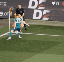 a soccer player with the number 23 on his jersey is kicking the ball