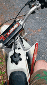 a person is riding a honda dirt bike on a road