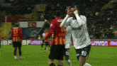 a soccer player wearing a white shirt with the number 19 on it