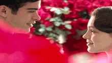 a man and a woman are looking at each other and smiling