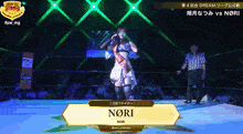 a female wrestler named nori is standing in a ring