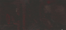 a blurred image of a man standing in a doorway with a light on .