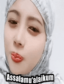 a woman wearing a hijab says assalamu ' alaikum