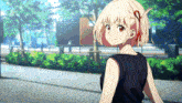 a girl with short blonde hair and red eyes is wearing a black dress