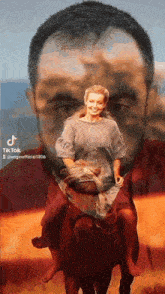 a man and a woman are riding on the back of a bull .