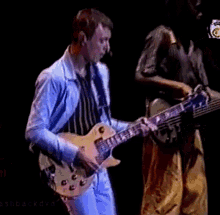 a man playing a guitar on a stage with the words ashbackdvd at the bottom