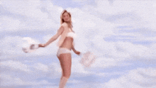 a woman in white underwear with a white bunny tail on her butt .