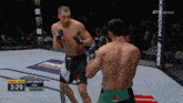 two men are fighting in a boxing ring with a sign that says kingdom audience