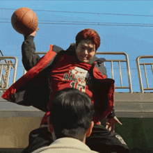 a man wearing a red jacket with the number 16 on it