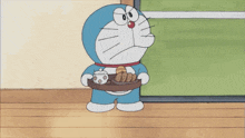 a cartoon character named doraemon is sitting on the floor eating something