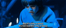 a boy in a blue shirt is reading a book and says but it 's only a story
