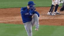 a baseball player in a blue jersey with the number 17 on it