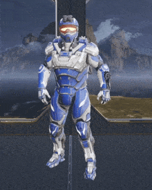 a man in a blue and white armor stands on a platform