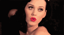 a close up of a woman 's face with the words " i heart katy perry " on the bottom right