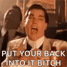 a man in a suit and tie is screaming and saying `` put your back into it bitch `` .