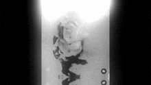 a black and white photo of a person laying in a bathtub .