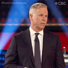 a man in a suit and tie is giving a speech on a cbs show
