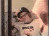 a man is taking a selfie in front of a mirror .