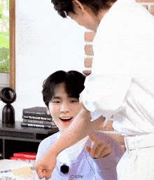 a man in a white shirt is putting his fist on another man 's shoulder