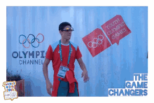 a man stands in front of a sign for the youth olympic games