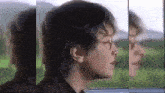 a young man with glasses is looking out of a window .
