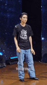 a young man wearing a black shirt that says the box world