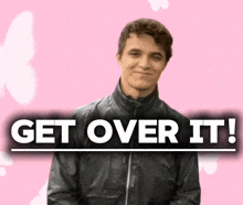 a man in a black jacket stands in front of a sign that says " get over it "