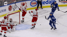 a hockey game is being played in front of an esso sign