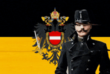 a man with a mustache is standing in front of a flag with a coat of arms