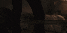 a man and a woman are dancing together in a dark room