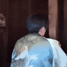 a man wearing a blue jacket with the word believe on it