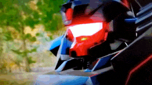 a close up of a robot 's head with a red light on it