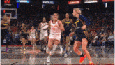 a basketball player wearing a number 4 jersey is dribbling a ball