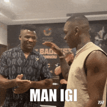 two men are standing next to each other and one of them says " man igi " on the screen