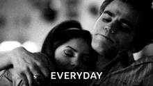a black and white photo of a man hugging a woman with the word everyday written above them