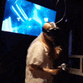 a person wearing a virtual reality headset is playing a video game