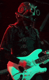 a man in a gas mask playing a guitar