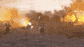 a blurry picture of a man riding a horse in front of a large fire