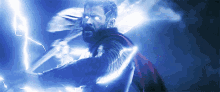 a man in a red cape is holding a lightning bolt