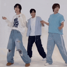 a man wearing a shirt that says ' but ' on it is dancing with two other men