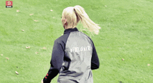 a woman wearing a black and grey shirt that says #forwarriors