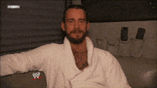 a man in a white robe with a w logo on the front