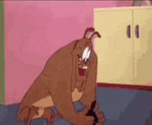 a cartoon dog is sitting on the floor in a room with a pink wall .