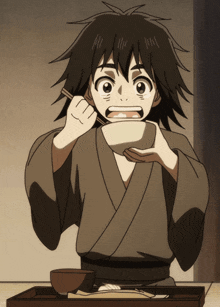 a young boy in a kimono is eating something from a bowl with chopsticks