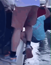 a person wearing a shirt that says rover on it climbs a boat