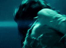 a blurry picture of a person in the water with a blue background